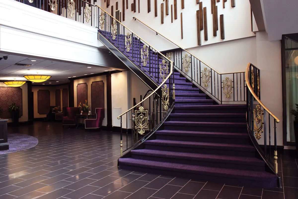 elegant-hotel-lobby Elegant hotel lobby with grand purple staircase, gold railings in Yonkers, NY